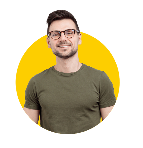 Agriculture translation services by Absolute translation services, Unshaven young man in casual t-shirt, keeps hands in pockets, poses over grey wall.