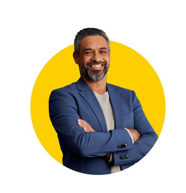 Arabic translations UK professional, Smiling indian mature businessman with arms crossed, wearing a blue blazer on gray background. 