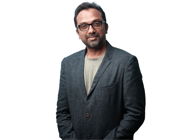 Marathi translation services, Portrait of a smiling man of Indian origin wearing a coat