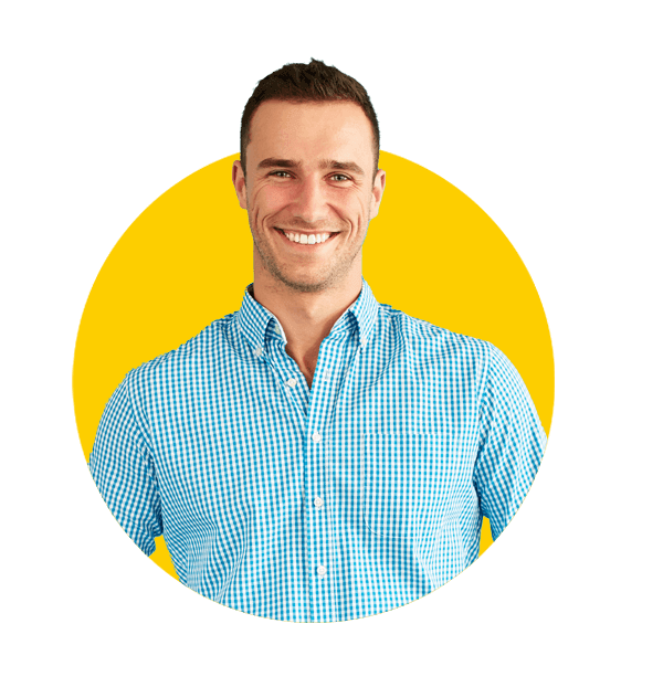 Mulitilingual DTP services, Smiling man with hands in pockets standing in front of turquoise wall. 