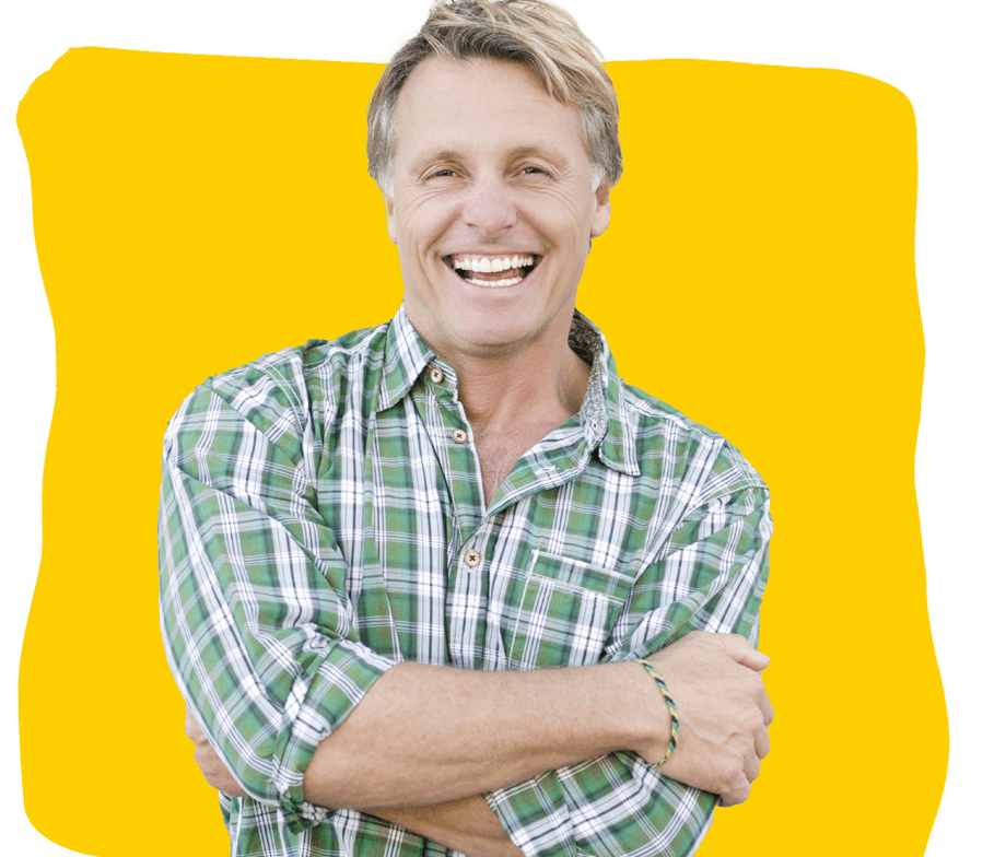 Professional belgian french translator, A color portrait photo of a happy laughing man in his forties wearing a green checked shirt.