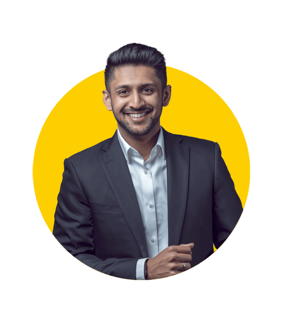 Professional Hindi translation services by Absolute Translations, young Indian man in black suit and white shirt against grey background.