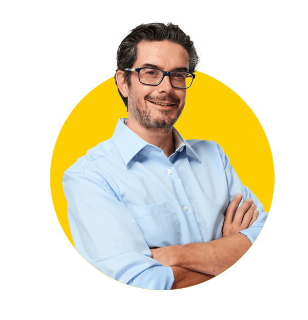 Slovak translation services by Absolute Translations, young handsome man in black suit smiling on dark background.