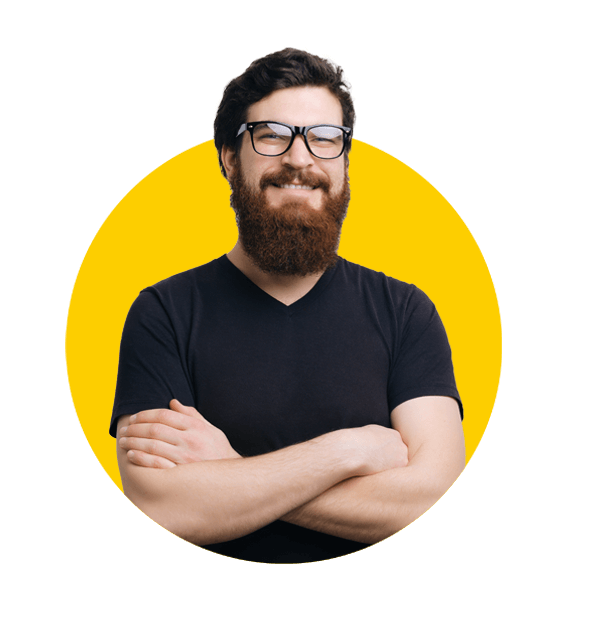 Basque translations UK, Portrait of a smiling bearded in glasses man standing with arms folded adn looking at camera.