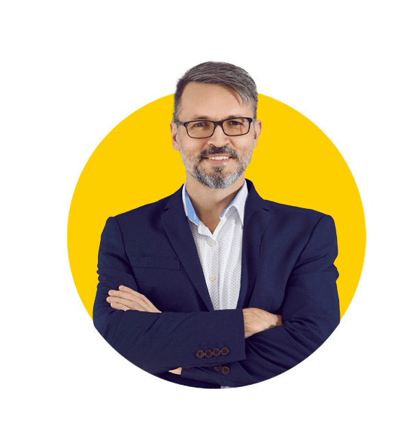 British council translations uk, Happy handsome mature businessman in a dark blue suit leaning against the gray wall of his office.