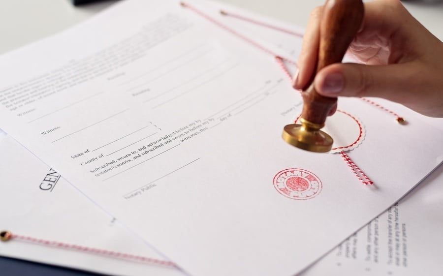 Official stamp being applied to a certified translation document