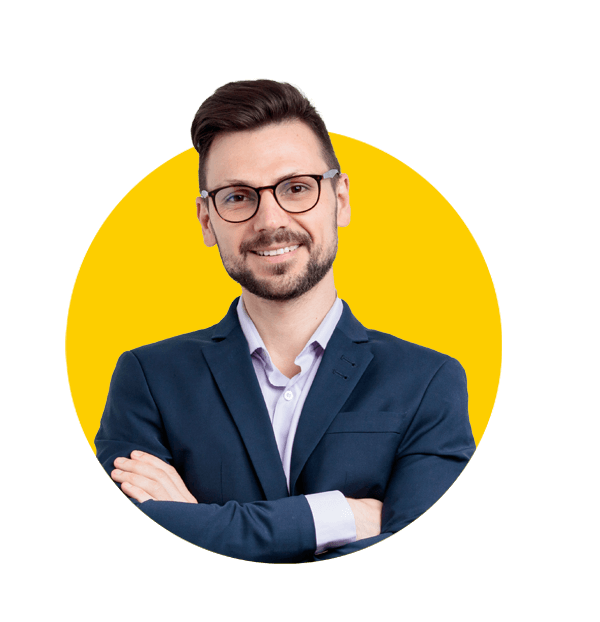 Professional Engineering translation services by Absolute translations, Smiling young man in a suit and glasses keeps his arms crossed. Isolated on grey background.