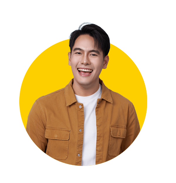 Professional Korean translation services by Absolute Translations, happy young Southeast Asian man laughing against blue studio background.