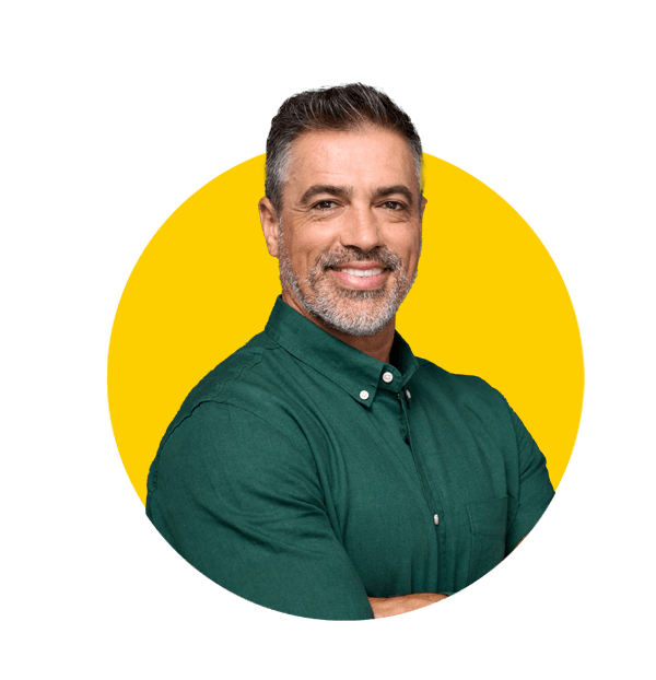 Urdu translation services by Absolute Translations, happy middle-aged businessman and entrepreneur smiling confidently.