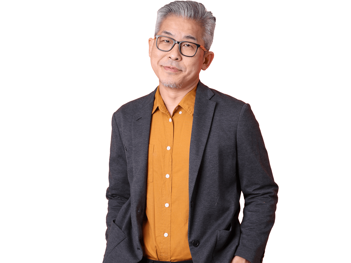 Burmese transcription services, The senior Asian business man standing on the orange background.