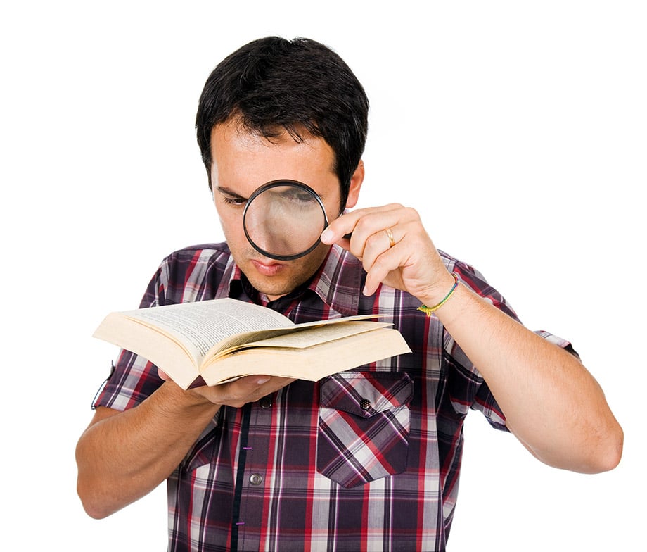 Dutch expert proofreader examining a book with magnifying glasses