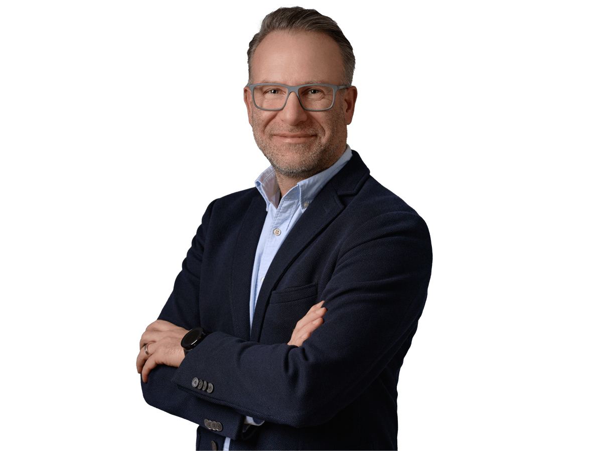 Financial translation services, Smiling mature businessman in glasses, wearing suit without a tie, standing against grey background 