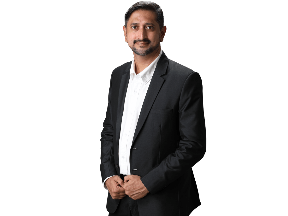Hindi localisation  services , Portrait of handsome Indian business man smiling, standing on dark gray background
