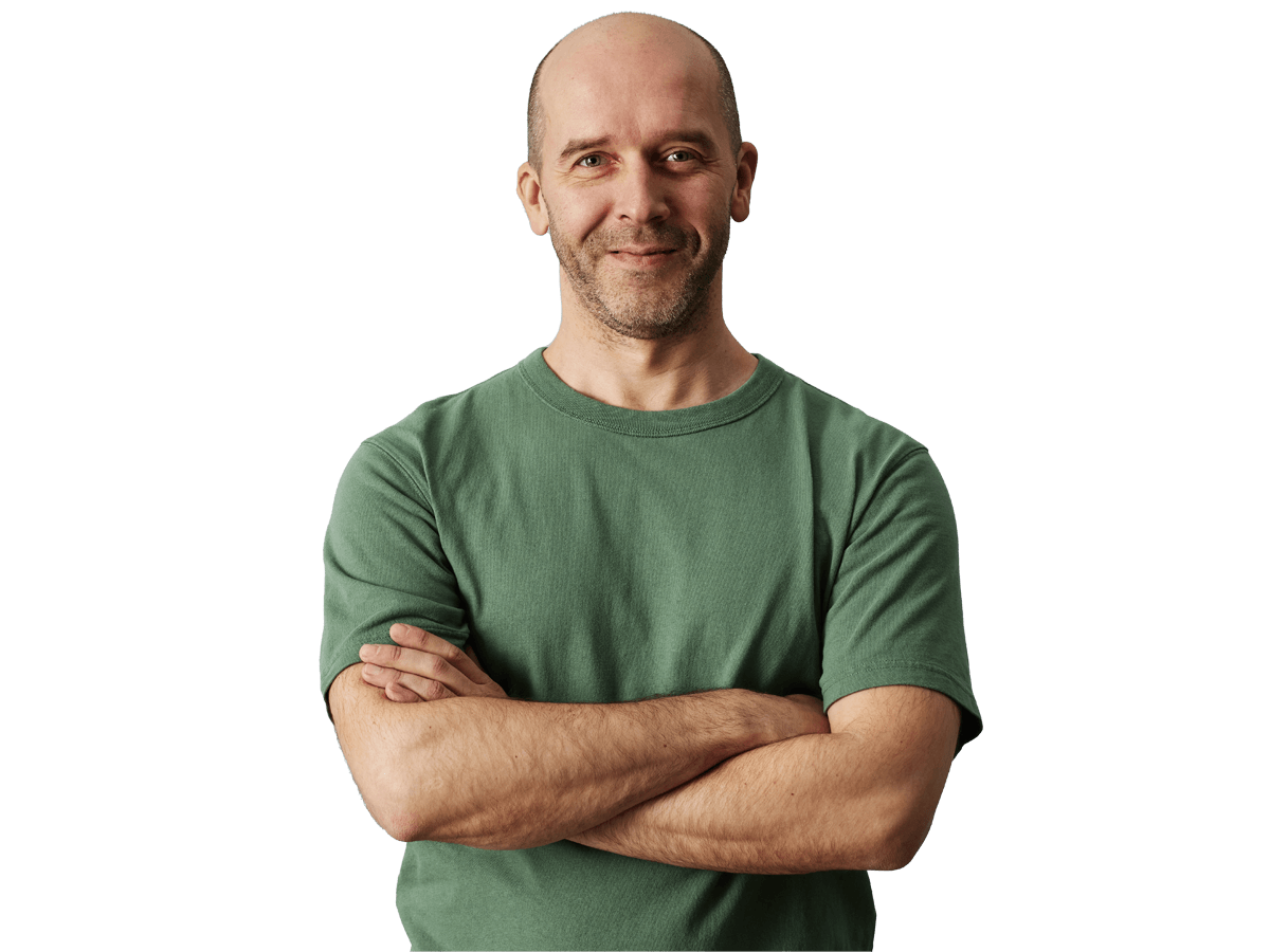 Luxembourgish translation services, Minimal waist up portrait of mature bald man smiling at camera while standing confidently with arms crossed